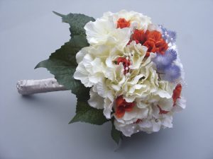 Hydrangea, Mist flower with Burnt Orange Bud Roses and Diamante. Stems wrapped in cream satin ribbon - from £85.00