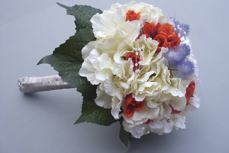 Hydrangea, Mist flower with Burnt Orange Bud Roses and Diamante. Stems wrapped in cream satin ribbon - from £85.00